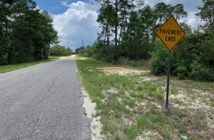 yellow diamond-shaped sign reads pavement ends